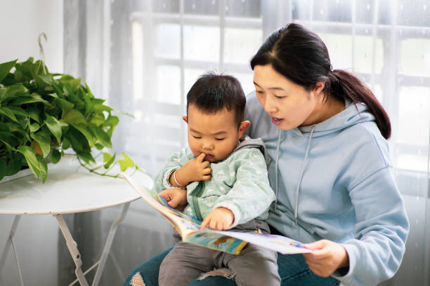 istock Woman with his son reading at home 1277090640