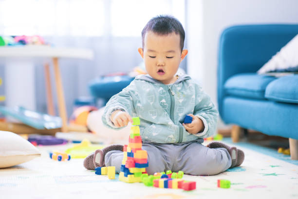 istock Baby boy playing with colorful toy blocks 1277090746