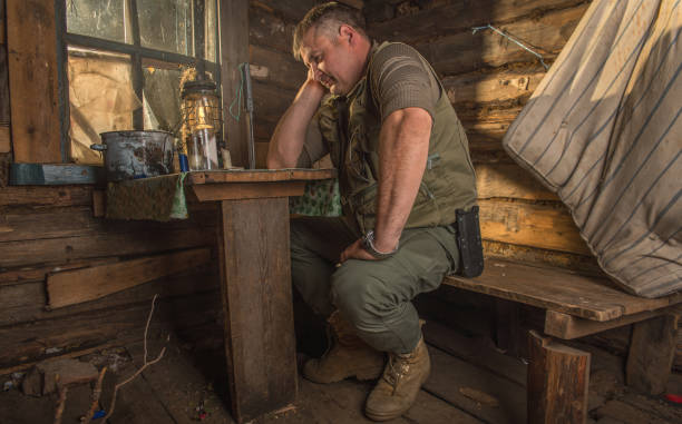 istock A man sitting at a table in a hut. 1277091725