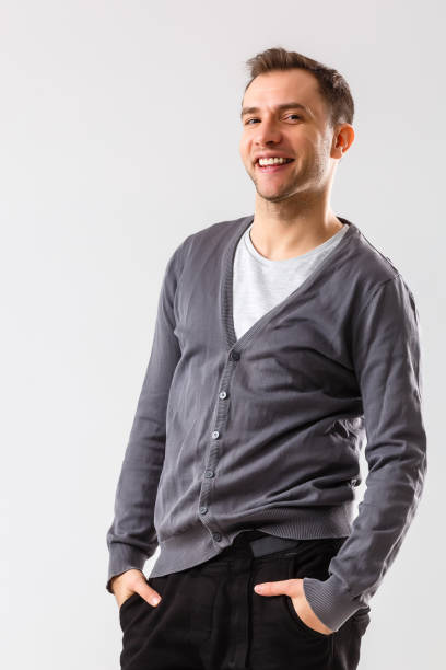 istock Casually handsome. Confident young handsome man keeping arms crossed and smiling while standing against white background 1277091895