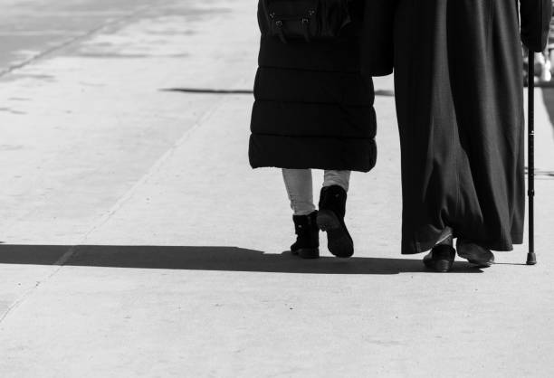 istock Low Section Of People Walking On Footpath 1277093537