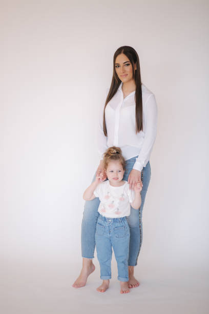 istock Little girl with mom in studio. White background 1277094128