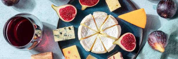 istock Cheese variety panorama, with wine and fresh fruit, overhead shot, flat lay 1277094149