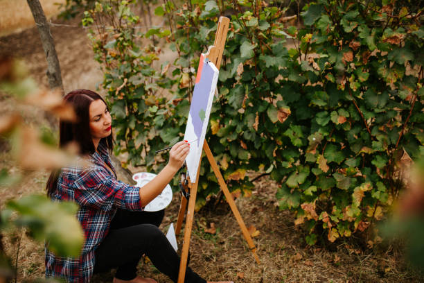 istock Creative woman painting in nature 1277096119