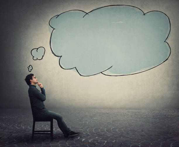 istock Side view businessman sitting on chair, keeps hand under chin, thoughtful gesture, and an empty thought bubble, thinking cloud, comes out of his head. Business employee focused on ideas and planning. 1277097197