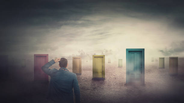 istock Rear view businessman in front of many different doors choosing one. Difficult decision, important choice, failure or success concept. Decisive ways to unknown future, business opportunity symbol. 1277097469