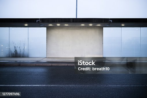istock Front view blank cement and frosted glass wall at outdoor 1277097496