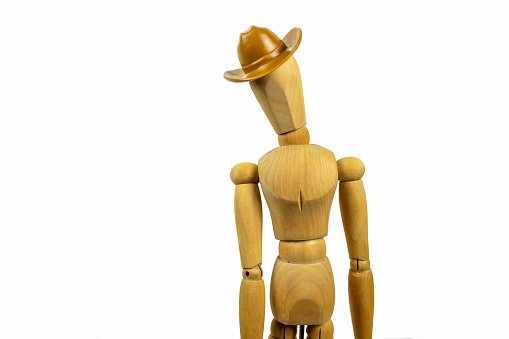 Wooden man in a cowboy hat on a white background.
