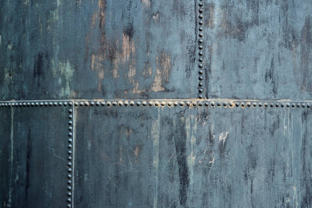 istock Part of an old storage container made of riveted iron plates, used and dirty, pattern, texture, background 1277098018