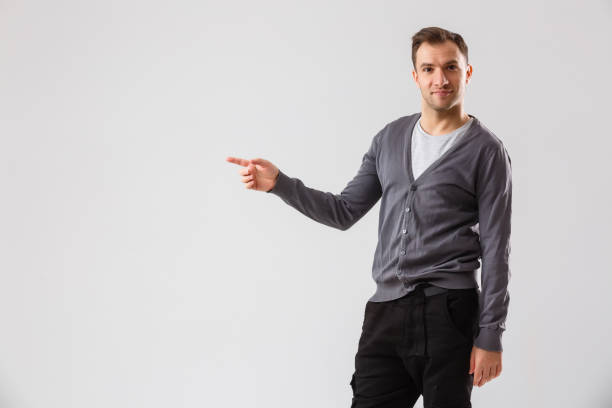 istock Young man presenting your product, isolated over a white background 1277098729