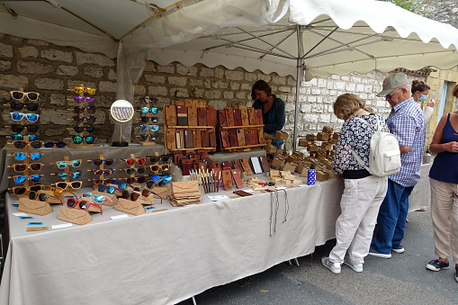 Monpazier, France: July 2020; Market stall at a summer street market in Monpazier selling wood and cork products