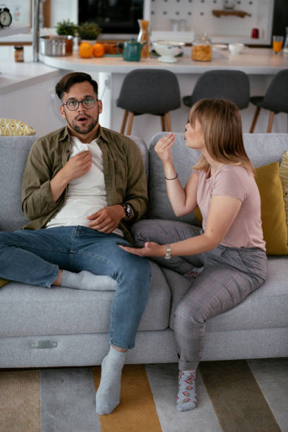 Boyfriend and girlfriend are arguing on the couch