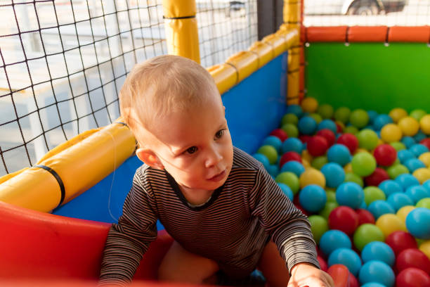 istock Baby Playing In Playground with Colorful Ball 1277100739