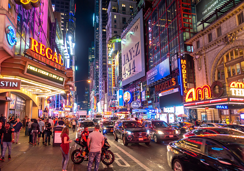 New York City, USA - October 7, 2017: Tourists in front of Broadway theatres in Times Square New York city at night