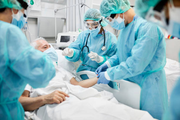 istock Doctors Examining Coronavirus Patient in Ward 1277102385