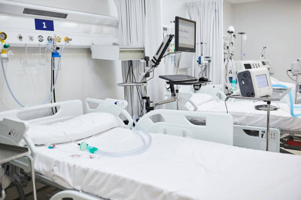 Interior of Intensive Care Unit at Hospital Empty bed in intensive care unit. Various medical equipment in ward. Interior of hospital. intensive care unit stock pictures, royalty-free photos & images