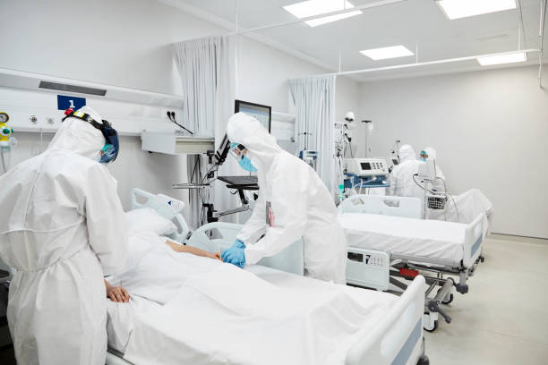 istock Doctors Operating Coronavirus Patient in Hospital 1277102553