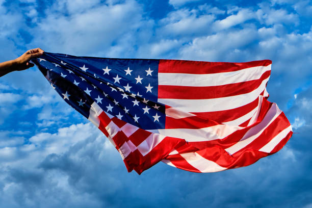 istock man waving an American flag on the wind 1277102902