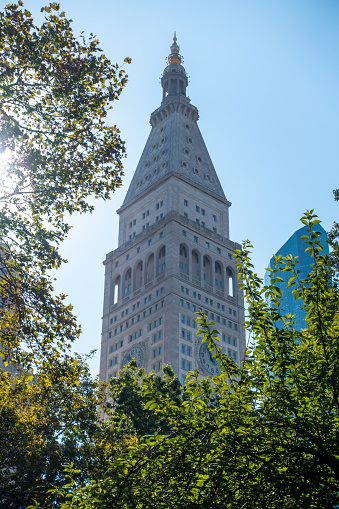 New York City, USA - August 9, 2019:people strolling among the famous skyscraper called Fatiron building in Manhattan during a sunny day
