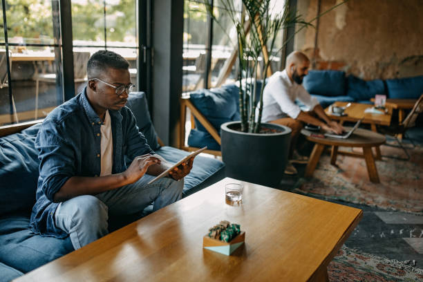 istock Two freelancers working in a coffee bar during corona virus 1277103127