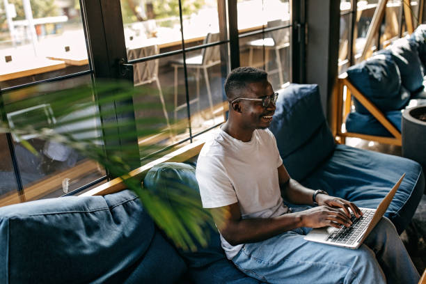 istock Young man sitting in coffee shop and working 1277104455