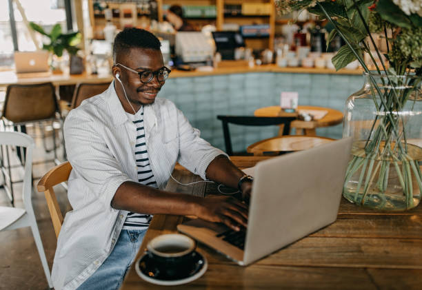 istock Young man sitting in coffee shop and working 1277104499