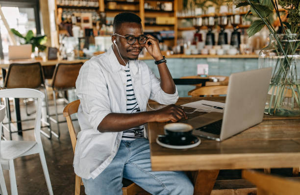 istock Young man sitting in coffee shop and working 1277104600