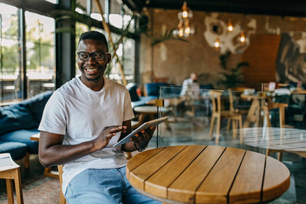 istock Young man sitting in coffee shop and working 1277104602