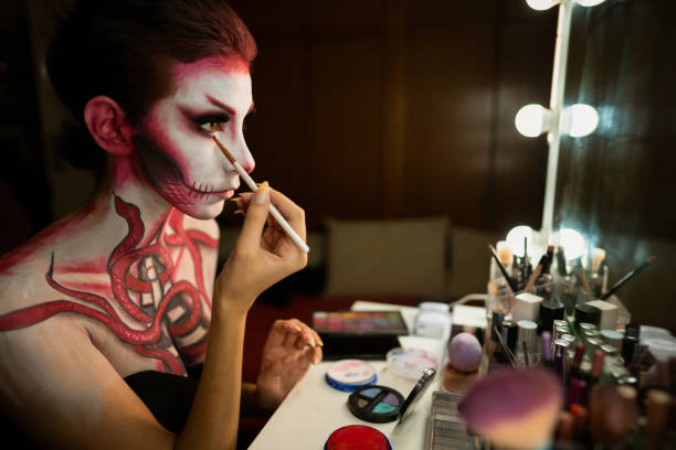 istock Young woman shading her eyes with make-up bruh at her make-up table 1277104781