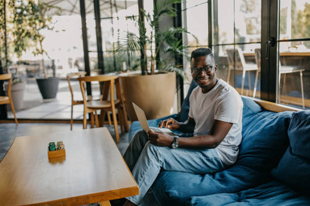 istock Young man sitting in coffee shop and working 1277104833