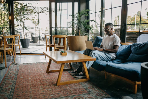 istock Young man sitting in coffee shop and working 1277104907