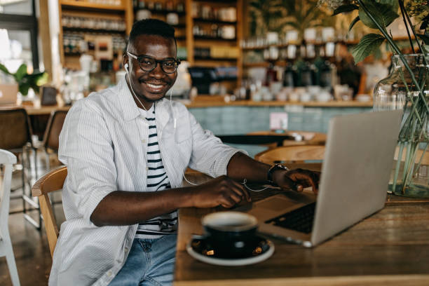 istock Young man sitting in coffee shop and working 1277105560