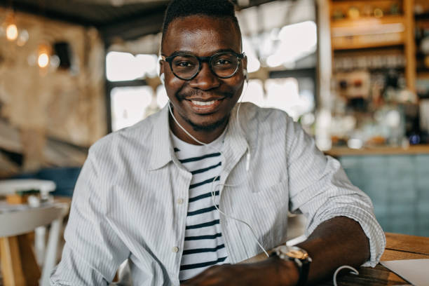 istock Young man sitting in coffee shop and working 1277105679