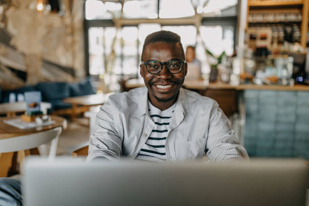 istock Young man sitting in coffee shop and working 1277105684