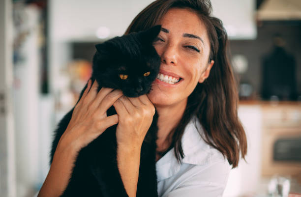 istock Cute Woman Hugging Her Black Cat 1277105777