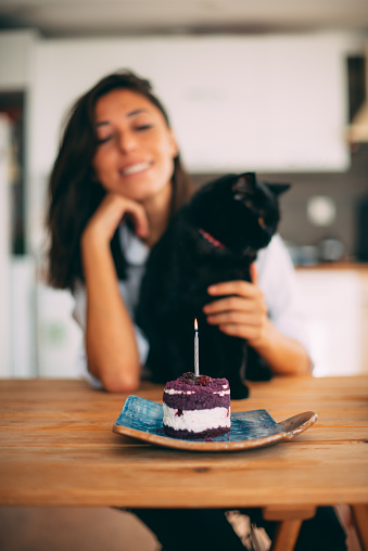Cute Woman Celebrating Her Birthday With Her Black Cat