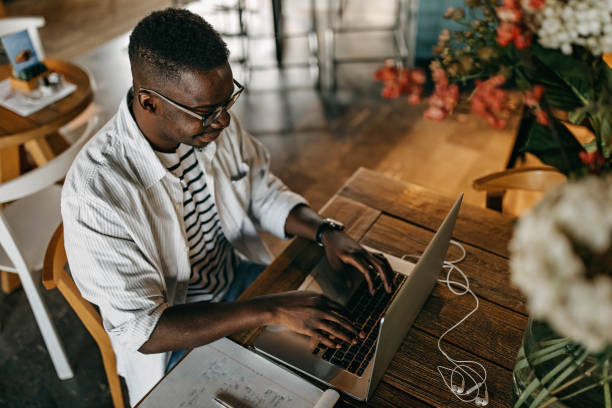 istock Young man sitting in coffee shop and working 1277105806