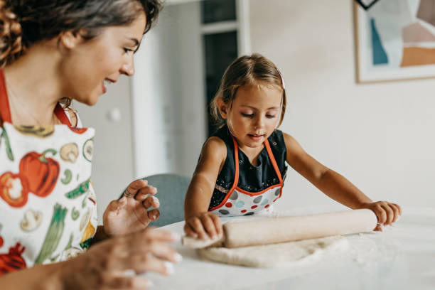 istock Mother and daughter make cookies 1277106036