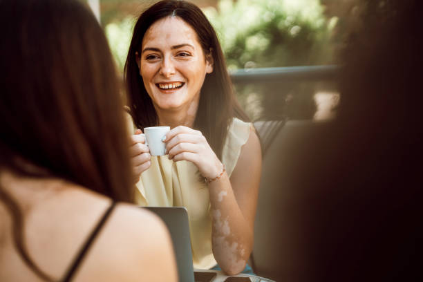 istock Beautiful young girl with skin problems sits in a cafe drinking coffee 1277106067