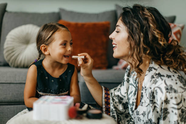 istock Mother and daughter apply make up 1277106133