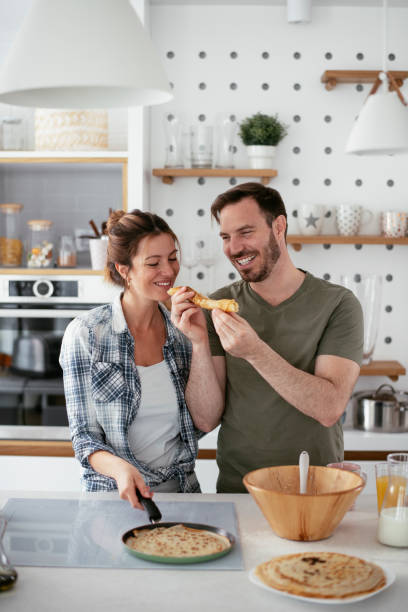 istock Young couple making pancakes at home. 1277106252