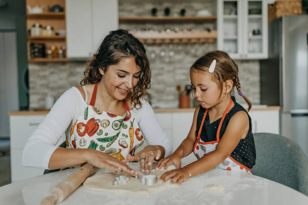 istock Mother and daughter make cookies 1277106253