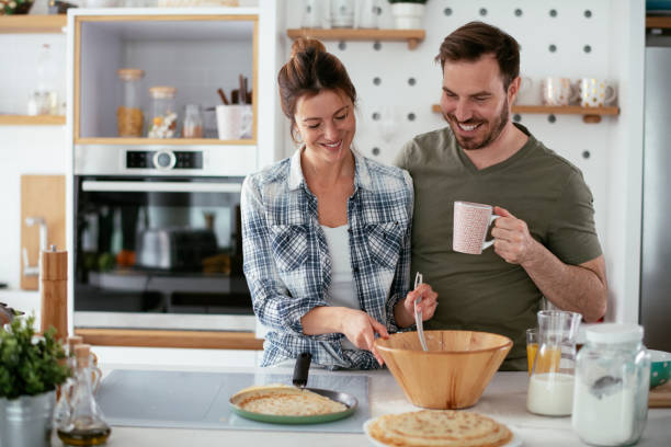 istock Young couple making pancakes at home. 1277106337