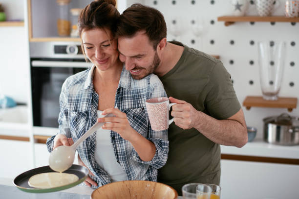 istock Young couple making pancakes at home. 1277106371