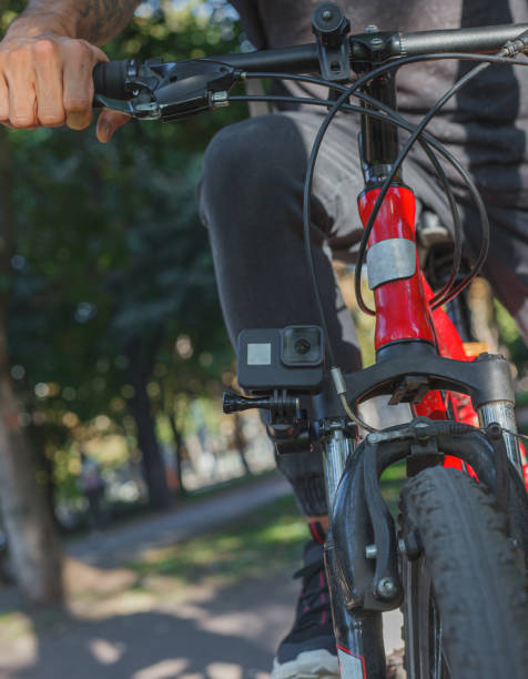 istock Action camera fixed next to the wheel of the bicycle on which the man rides 1277106464
