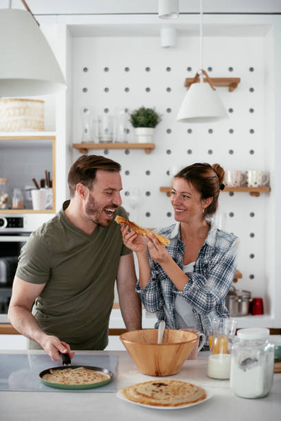 istock Young couple making pancakes at home. 1277106478
