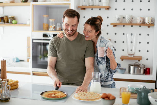 istock Young couple making pancakes at home. 1277106485