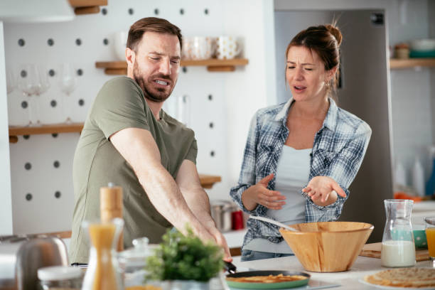 istock Young couple making pancakes at home. 1277107017