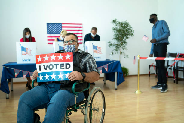 istock Mid aged man in a wheel chair on election day 1277107425