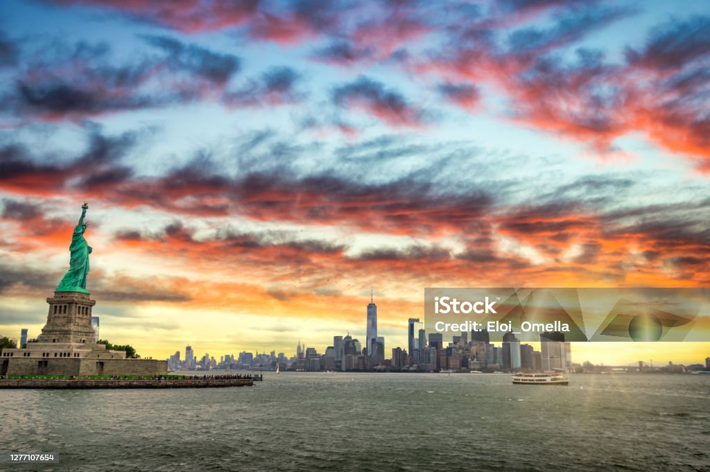 Sunrise in Ney York City Statue of Liberty and New York City skyline at sunrise, USA New York City Stock Photo